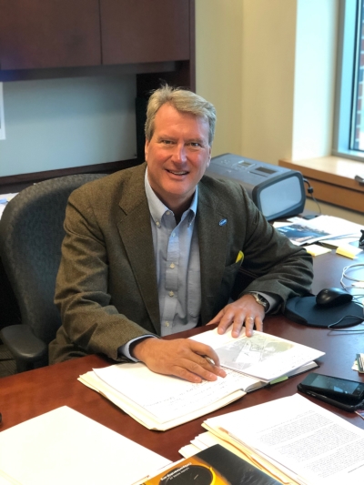 Mark Geise sitting at his desk.