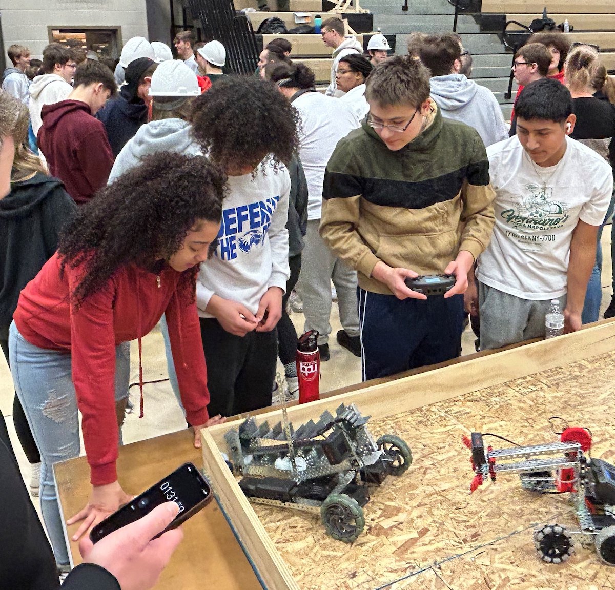 Robotics team controlling robot at a Dream It Do It WNY event.